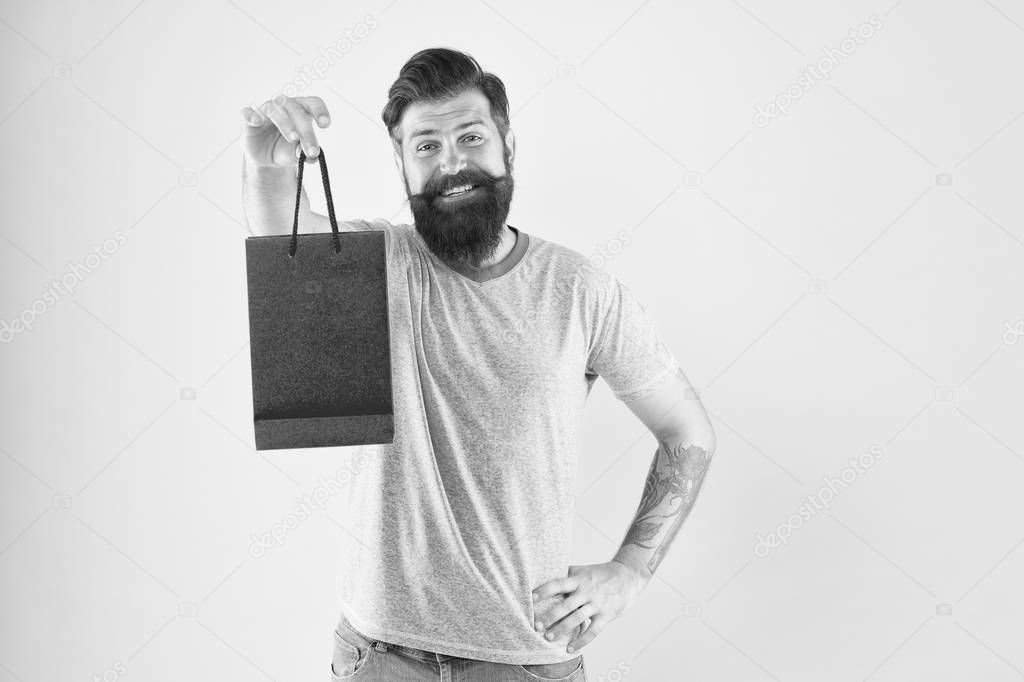 Purchase concept. Male motives for shopping appear to be more utilitarian. Aspects can influence customer decision making behavior. Hipster hold shopping bag. Man with purchase. Impulse purchase