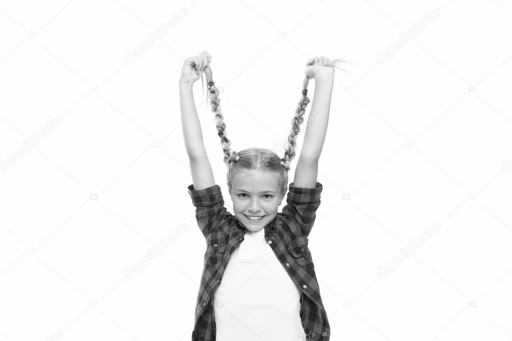 Long and plaited. Happy small girl hold long blond braids. Adorable little child smile with long plaited hair. Long hair growth stimulant. Beauty salon. Kids barber