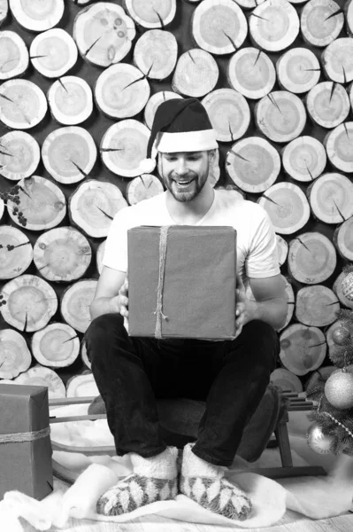 Père Noël homme avec boîte assis sur fond de bois journal — Photo
