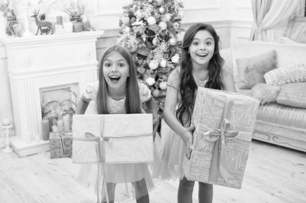 Подарки на Рождество. Маленькие девочки с рождественскими подарками. С Новым годом. счастливые маленькие сестры празднуют зимний праздник. Рождественское время. Семья. Все, что я хочу на Рождество. this is for you — стоковое фото