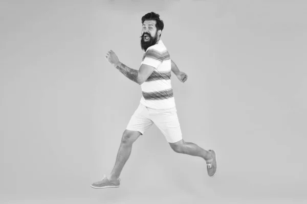 time to relax. active runner in move. Hurry up. Summer vacation. Man bearded hipster run yellow wall. Guy beard striped shirt. Freedom jump. Sale and discount. rush hour. lets go seasonal shopping