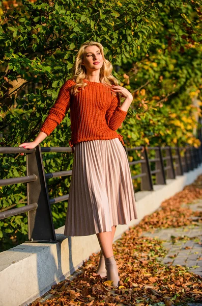 Pleated skirt fashion trend. Autumn stylish outfit. Fall fashion. Adorable lady enjoy sunny autumn. Fashionable clothes. Girl gorgeous blonde. Femininity and tenderness. Woman walking in autumn park