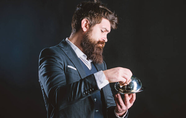 Waiter luxury restaurant. Man well groomed gentleman formal suit hold little cloche. Serving and presentation. Elite luxurious. Secret under cloche. Exclusive food hidden cloche. What is under cloche