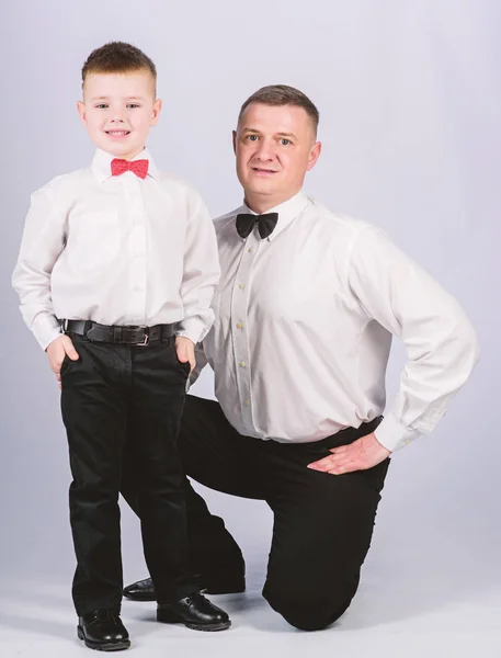 trust and values. patrician male fashion. happy child with father. business meeting party. father and son in formal suit. tuxedo style. little boy with dad businessman. family day. patrician concept