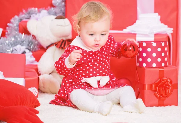 Christmas gifts for toddler. Things to do with toddlers at christmas. Little baby girl play near pile of gift boxes. Family holiday. Gifts for child first christmas. Christmas activities for toddlers Stock Picture