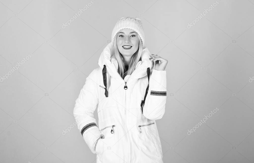design is perfect. woman in padded warm coat. happy winter holidays. New year. beauty in winter clothing. cold season shopping. flu and cold. seasonal fashion. girl in beanie hat. faux fur fashion