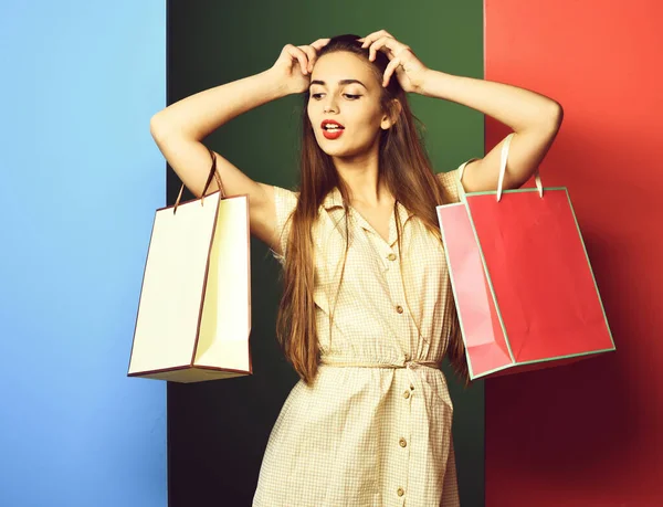 Serious colorful girl with pegs — Stock Photo, Image