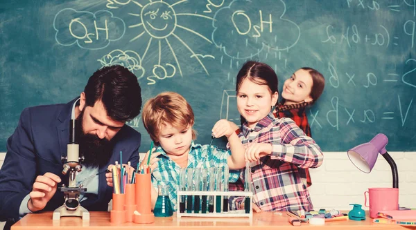 Glückliche Kinderlehrerin. Experimentieren mit Chemikalien oder Mikroskop im Labor. Biologischer Unterricht. Mikroskop. zurück zur Schule. Biologie-Schule Laborausstattung. Bakterien unter die Lupe nehmen — Stockfoto