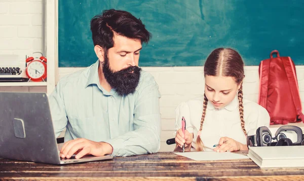 Homeschooling with father. Find buddy to help you study. Private lesson. School teacher and schoolgirl with laptop. Study modern technologies. Man bearded pedagogue teaching informatics. Study online