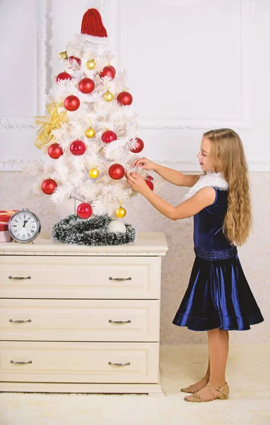 Spread christmas cheer. Kid happy because holiday season arrives. Winter holiday concept. Very special time of year. Family holiday concept. Girl velvet dress feel festive near christmas tree — Stock Photo, Image