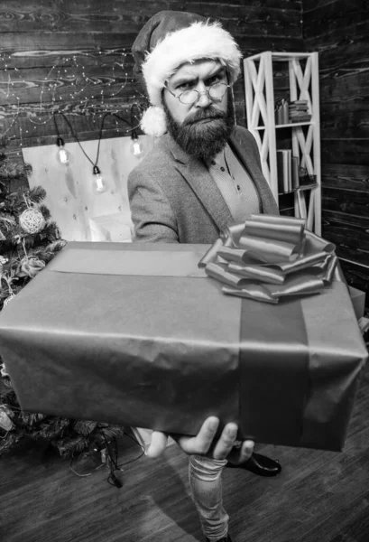 Spread happiness and joy. Bearded guy with eyeglasses carry present box. Delivery christmas present. Delivery service. Christmas is coming. Gifts delivery. Santa courier. Man santa hat deliver gift — Stock Photo, Image