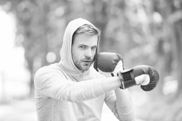 Be strong. man in boxing gloves punching. Sport and sportswear fashion. boxer man in hood. ready to fight. knockout and energy. Sport success. Boxing school. training with coach. healthy fitness — Stock Photo, Image