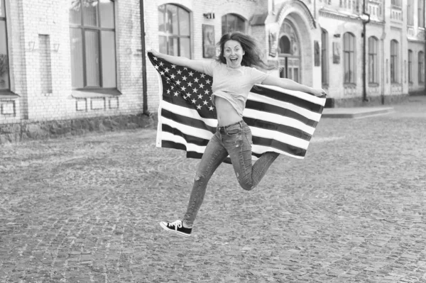 Being free and live life fully. Happy girl jumping free with american flag outdoor. Sensual woman celebrating freedom and independence. Rights of conscience and free will. Free and independent