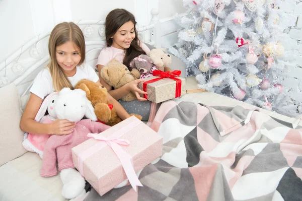 ギフト付きの寝室の小さい子供。優しさの概念。クリスマスの雰囲気。驚きだ。プレゼントが包装された。だから贈り物に触れた。クリスマスの前夜に小さな女の子のベッド。幸せな子供クリスマスの精神 — ストック写真