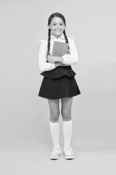 Raising independence. Schoolgirl wear school uniform. Knowledge day. Girl with copy book or workbook. Kid student ready with homework. School girl excellent pupil prepared essay or school project — Stock Photo, Image