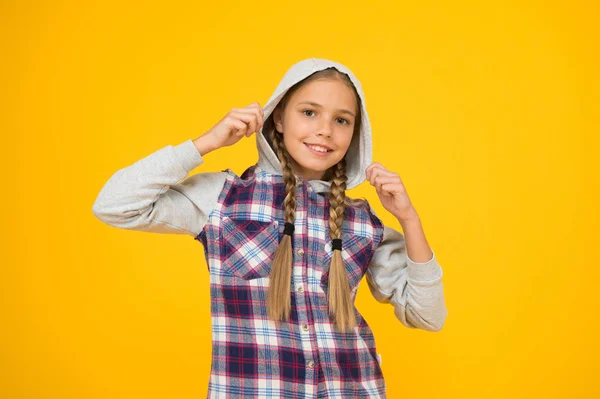 Casual style. Cute braided girl. Kid long hair. Small girl checkered shirt. Happy international childrens day. Little girl yellow background. Good mood concept. Positive vibes. Sincere emotions — Stock Photo, Image