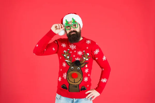 Santa man party glasses. man santa hat red background. merry christmas. hipster man reindeer on knitted sweater. winter holiday. cold season clothes. happy new year. red is christmas color — Stock Photo, Image