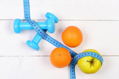 Teyp, ağırlık dambıl diyet konsepti için ölçme ile portakal, elma