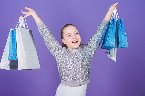 Get better looking. Black friday. Sale discount. Shopping day. Child hold bunch packages. Kids fashion. Birthday girl. Surprise gift. Girl with shopping bags violet background. Shopping and purchase — Stock Photo, Image