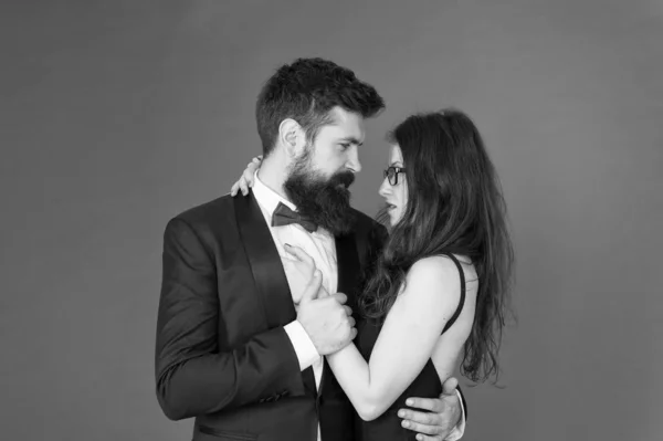 We are together. Couple in love red background. Loving couple hug in formal wear. Married couple celebrate wedding anniversary. Couple of sensual woman and bearded man. Valentines day. Romance. Love — Stock Photo, Image