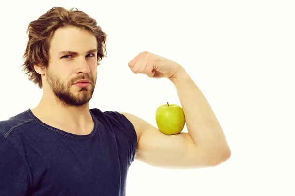 Caucásico chico con confianza mirada celebración verde manzana en el músculo — Foto de Stock