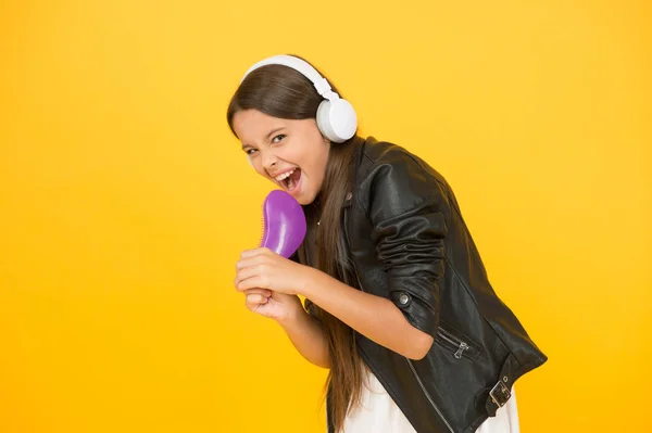 Recording studio. Beautiful voice. Developing voice. Voice synthesis will change the way music distribution works. Small girl listening music headphones. Musical education. Singing hairbrush mic — Stock Photo, Image