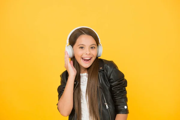 Music trends shaping future. Musical taste. Musical accessory. Gadget shop. Small girl listening music wireless headphones. Stereo sound. Musical education. Perception of sounds. Learning lyrics