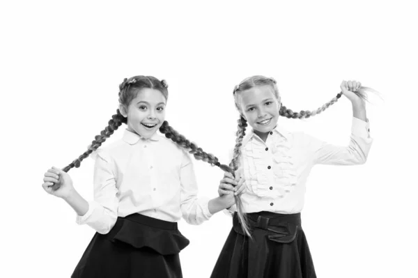 Helping hair grow faster. Adorable little children taking care of long hair. Cute small girl holding long hair braids isolated on white. Wearing long hair in plaits for school — Stock Photo, Image