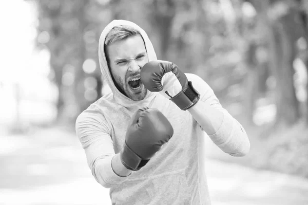 Boxing training endurance. Man athlete concentrated face with sport gloves practicing boxing nature background. Boxer ready to fight. Sportsman boxer training with boxing gloves. Nice punch — Stock Photo, Image