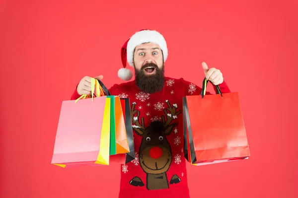 Delivering your purchase. Shopping with pleasure. Man bearded hipster wear winter sweater hold shopping bags. Buy new year gifts. Shopping for presents. Nice purchase. Discount for club members — Stock Photo, Image