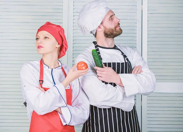 Vegetarian family. Woman and bearded man cooking together. Chefs of organic food restaurant. Cooking healthy food. Fresh vegetarian healthy food recipe. Join healthy lifestyle. Fresh vegetables