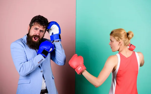 Couple in love fighting. problems in relationship. sport. bearded man hipster fighting with woman. family couple boxing gloves. knockout punching. who is right. win the fight. Strength and power