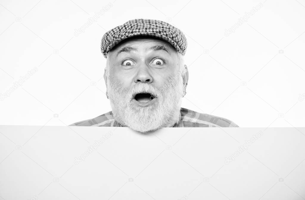 Pensioner grandfather in vintage hat poster information copy space. Elderly person. Announcement concept. Senior bearded emotional man peek out of banner place announcement. Event announcement