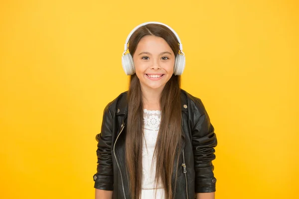 Happy smile. hipster urban style girl. lifestyle concept. biker kid in headset. small girl in leather jacket. autumn fashion style. child listen rock music. little school radio dj. lady DJ long hair — Stock Photo, Image