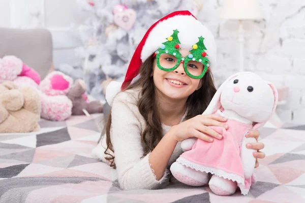 Toy never sleeps. Little girl play with toy bunny. Happy child got toy gift from Santa. Christmas gift or present. Saint Nicholas Day. New Year Eve. Toy and imagination. Game and play — Stock Photo, Image