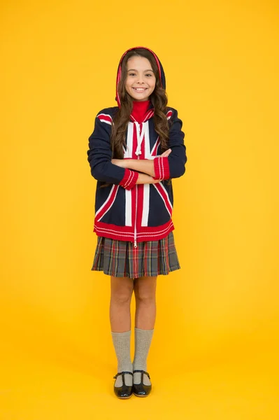 English lesson. Union Jack Flag. small girl uniform. kid with english flag on jacket. go study to england. learn english language. british school in england. vacation in great britain. travel concept