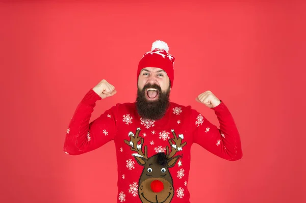 I am winner. Join holiday party craze and host ugly christmas sweater party. Buy festive clothing. Sweater with deer. Hipster cheerful bearded man wear winter sweater and hat. Happy new year — Stock Photo, Image