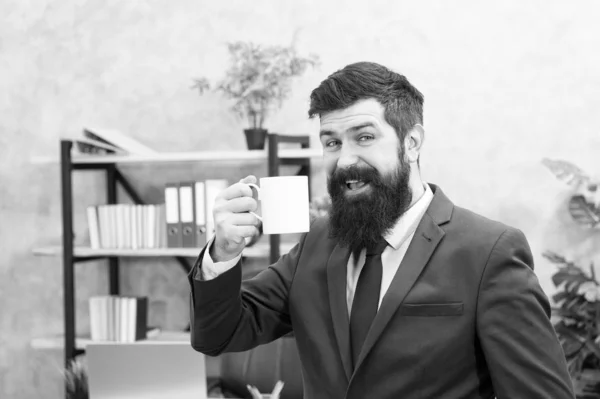 Coffee is always good idea. Man bearded businessman hold cup stand office. Start day with coffee. Successful people drink coffee. Coffee relaxing break. Boss enjoying energy drink. Caffeine addicted