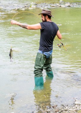 Her zaman oltaya takılır. Yaz haftasonu. Büyük balık avı. Olgun adam balık tutuyor. Balık tutan adam. Elinde olta olan balıkçı. Sudaki sakallı balıkçı. Hobi ve spor aktiviteleri. tutucu