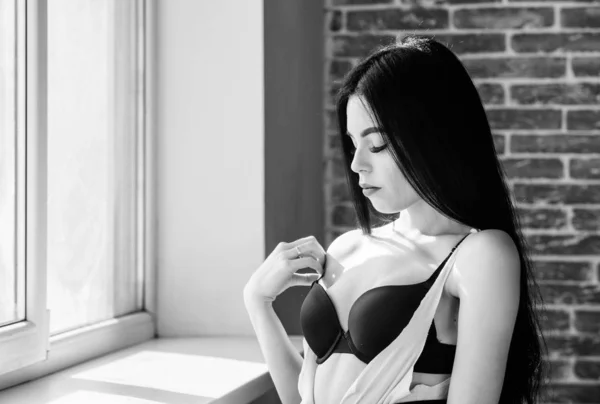 Passionate mysterious lover. Enjoying morning sunlight. Sensual girl sexy breasts relaxing near windowsill. Attractive female sexy lingerie at home. Stunning sexuality. Sexual costume for pleasure — Stock Photo, Image