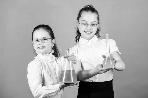 Small kid study. Chemistry lesson. Having fun with chemistry. Educative experiment. Chemistry fun. Knowledge day. Schoolgirl with colorful chemical liquids. Education concept. Safety measures