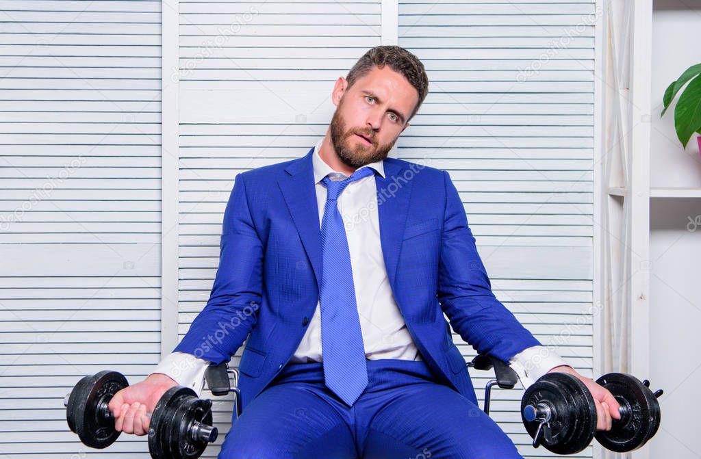 Despondent by work. Feel tension in muscles. Pressure tension stress. Mental and emotional tension. Man raise heavy dumbbells. Businessman manager exhausted. Sport healthy lifestyle. Downcast concept