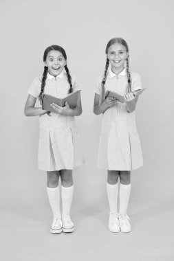 notlar alma. Küçük kızlar edebiyatı sever. eski okul. retro üniformalı mutlu arkadaşlar. vintage çocuk moda. Okula geri dön. küçük kızlar çalışma kitabı ve not defteri tutun. çocuklar için ansiklopedi kitap