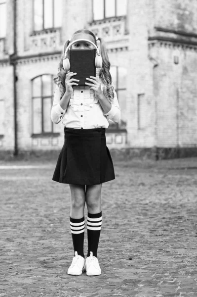 Dünyanızı açın. eski okul müziği. Okula geri dön. e-öğrenme. vintage çocuk moda. küçük mutlu kız e-kitap dinlemek. kulaklık teknolojisini kullanarak. şık retro üniformalı kız öğrenci sesli kitap dinle — Stok fotoğraf