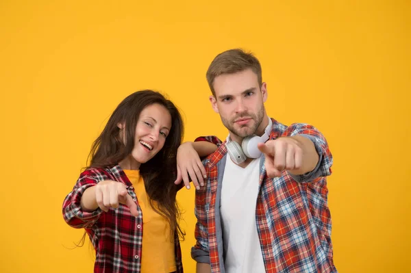 Simple casual clothes. Couple feeling comfortable. Country music concept. Country style. Woman and man wear checkered shirt. Rustic and country. Sexy people. Youth fashion. Fashionable outfit