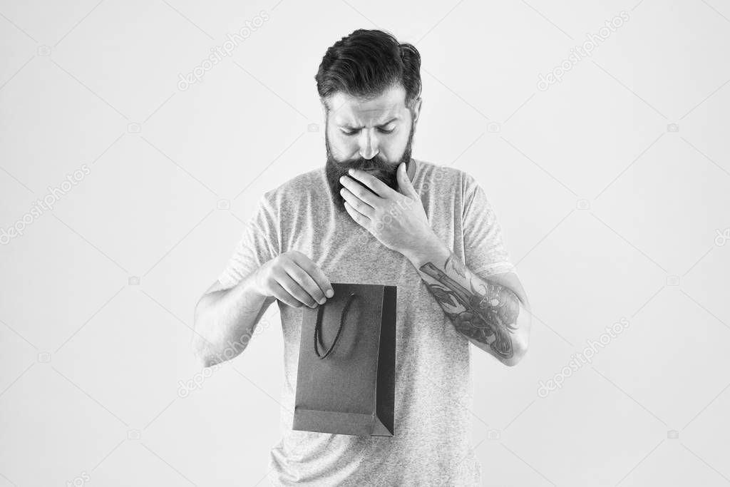 little pleasantness. bearded man go shopping. mall for men . mature male beard with fashion purchase. interested hipster hold paperbag. Man with gift package. Buy product. what is inside