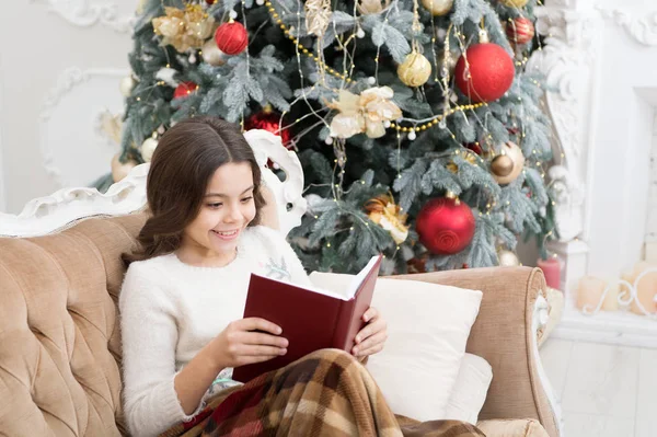 Book to read over winter break. Happy book reader. Small child read Christmas book. Little girl enjoy reading on new year eve. Holiday book sale. Library. Bibliopole. A page a day