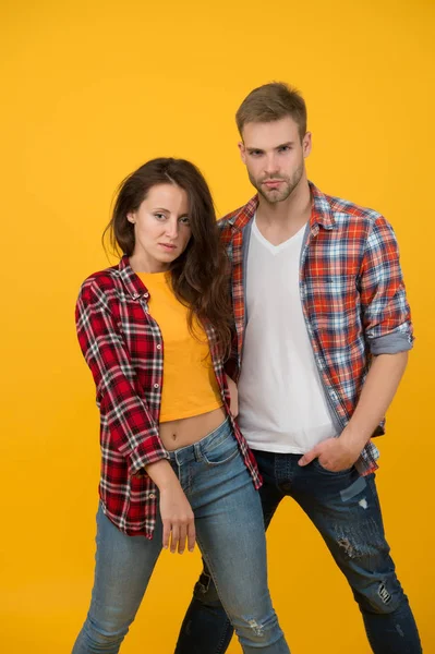 Youth fashion. Fashionable outfit. Simple casual clothes. Couple feeling comfortable. Country music concept. Country style. Woman and man wear checkered shirt. Rustic and country. Sexy people