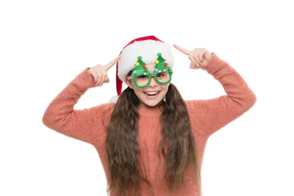 Check this out. Christmas holiday. Small girl in santa hat. Having fun. Happy child christmas tree eyewear accessory booth props. Little santa. Christmas event and entertainment. Happy about new year — Stock Photo, Image