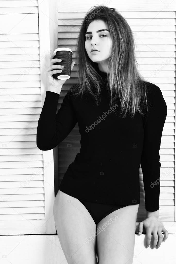 pretty cute sexy girl posing in black bodysuit with cup